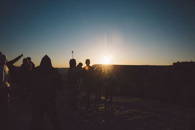 Silhouette people hiking at grand canyon national park during sunset