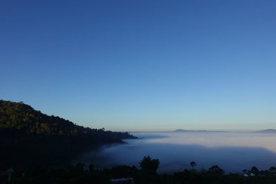 Scenic view of silhouette mountains against clear blue sky