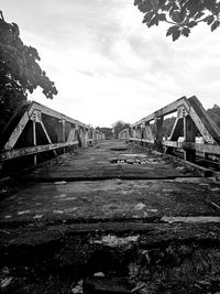 View of railroad tracks by building against sky