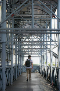 Full length of man walking on bridge