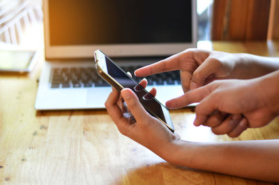 Midsection of woman using mobile phone