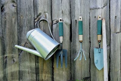 Gardening tools hanging on fence