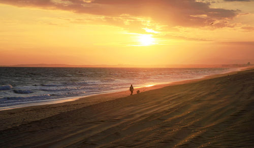 Scenic view of beach against sky during sunset