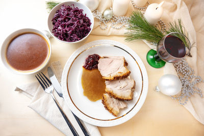 Cropped hand of person holding food on table