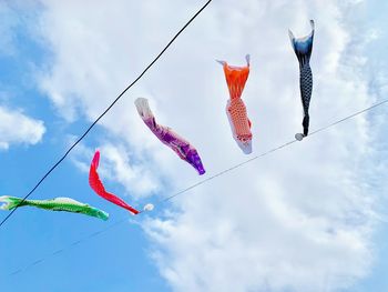 Low angle view of fish hanging against sky