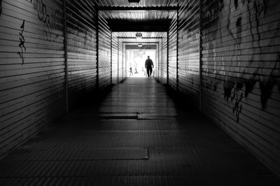Rear view of woman walking in corridor