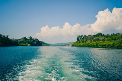 Panoramic view of sea against blue sky