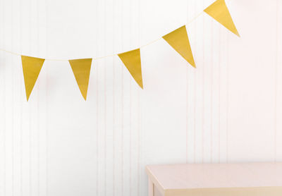 Golden bunting flags over an empty table. mock up scene, stage for product presentation. 