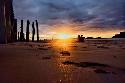 Scenic view of beach against sky during sunset