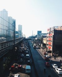 High angle view of traffic on road amidst buildings against sky