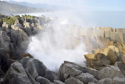Panoramic view of sea and rocks against sky