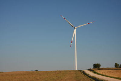 Wind turbine on field in a sunny day