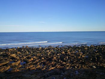 Scenic view of sea against clear blue sky