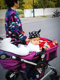 Cute girl riding bicycle on street