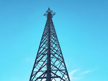 Low angle view of communications tower against blue sky