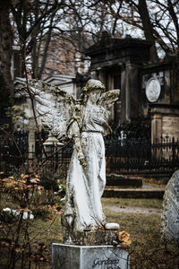 Statue against trees