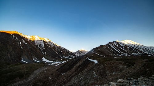 Scenic view of snowcapped mountains against clear sky