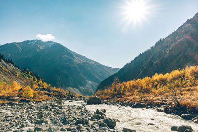 Scenic view of mountains against sky during sunny day