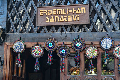 Low angle view of information sign hanging on building