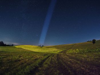 Scenic view of field against sky at night