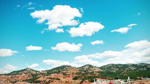 Low angle view of mountains against blue sky