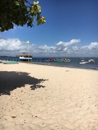 View of beach against cloudy sky