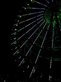 Low angle view of illuminated lights against sky at night