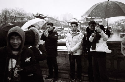 Group of people standing in rain