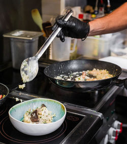 Cropped hand of man preparing food