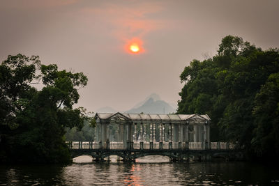 Scenic view of river against sky at sunset