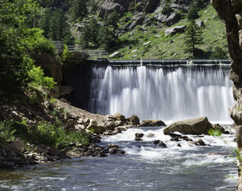 Scenic view of waterfall against trees