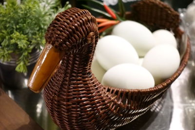 High angle view of eggs in basket on table