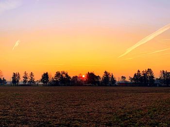 Scenic view of field against sky during sunset