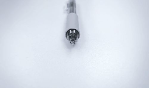 Close-up of ballpoint pen on gray background