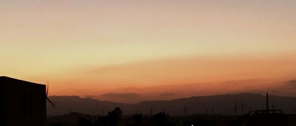 Scenic view of silhouette mountains against dramatic sky