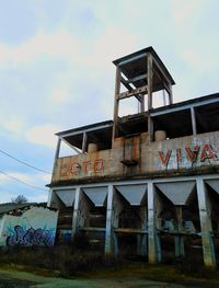 Low angle view of abandoned house against sky