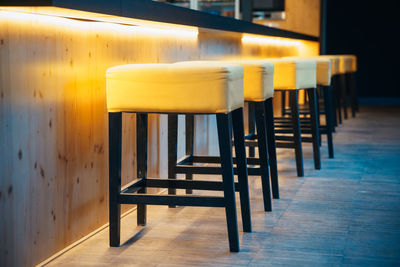 Empty stools in row at restaurant