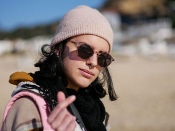 Portrait of young woman wearing sunglasses at beach