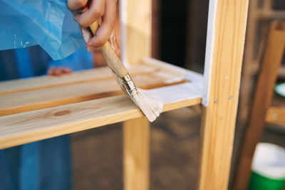 Close-up of person working on wood