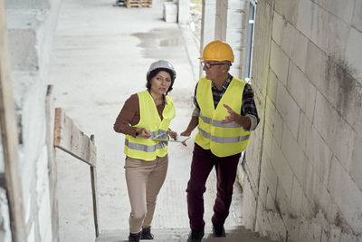 Rear view of woman standing against wall