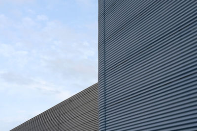 Low angle view of corrugated iron against sky