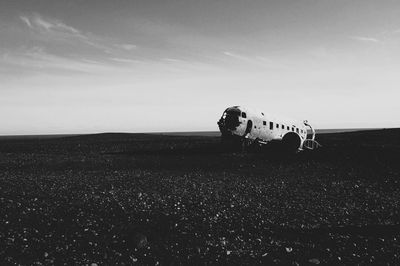 Airplane on field against sky