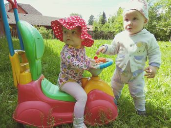 Siblings playing on grass