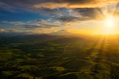 Scenic view of dramatic landscape against sky during sunset