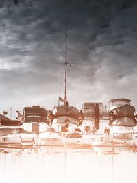 Sailboats in amusement park against sky