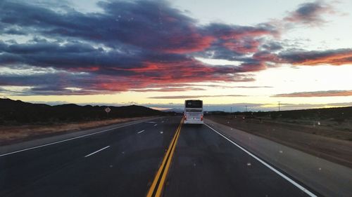 Road against dramatic sky during sunset