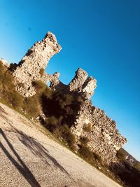 Low angle view of old ruin against blue sky