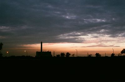 Silhouette of landscape against cloudy sky