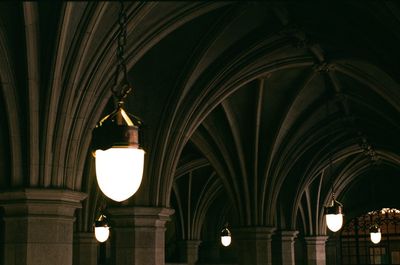 Low angle view of illuminated lamp at night