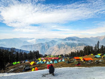 Panoramic view of base camp against sky and snow capped mountains.